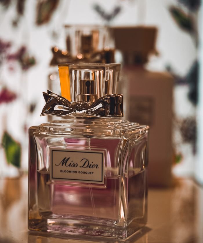 Home Elegant Miss Dior perfume bottle with blooming bouquet design, signifying luxury.