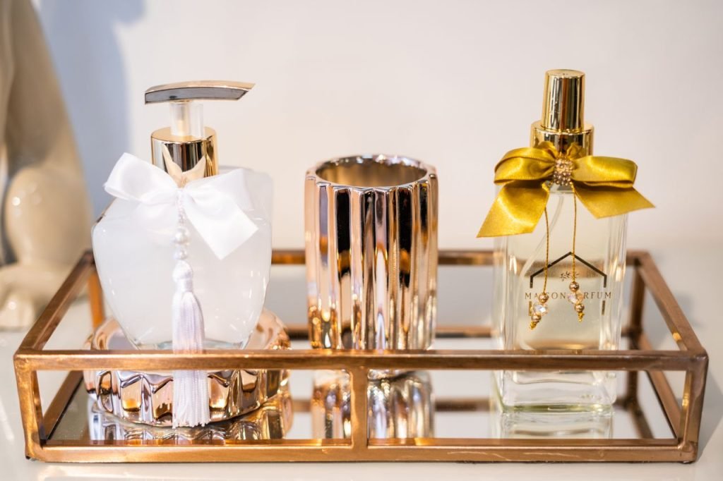 Close-up of decorative perfume bottles on a gold tray, showcasing elegance and style.